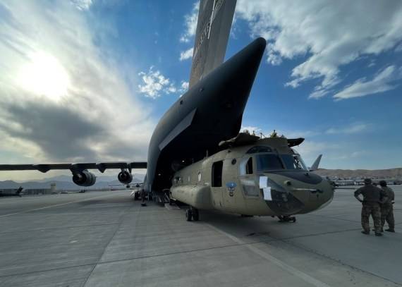 A CH-47 Chinook is loaded onto a U.S. Air Force C-17 Globemaster III at Hamid Karzai International Airport in Kabul, Afghanistan, on Aug. 28, 2021. (U.S. Central Command Public Affairs/Handout via Xinhua/IANS)