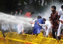 Police use water during a  Congress protest against Modi Government