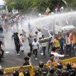 New Delhi: Police personnel use water cannons to disperse BJYM members during their protest against Delhi CM Arvind Kejriwal demanding dismissal of Health Minister Satyendar Jain from the party at Chandgi Ram Akhada in New Delhi on Wednesday, July 20, 202